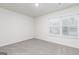 Neutrally painted bedroom features carpeting, recessed lighting, and a window at 295 Limestone Circle, Conyers, GA 30013
