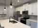 Modern kitchen with white cabinets, stainless steel appliances, and quartz countertops at 368 Cantrell Drive, Dallas, GA 30157