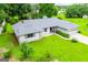 Well-maintained one-story home featuring a spacious yard, mature trees, and an attached two-car garage at 65 Pine Haven Ct, Carrollton, GA 30116