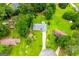 Aerial shot of a home and landscaped backyard, with trees surrounding the perimeter of the lot at 65 Pine Haven Ct, Carrollton, GA 30116