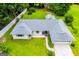 Aerial view of a well-kept home with a spacious yard, an attached garage, and mature trees at 65 Pine Haven Ct, Carrollton, GA 30116