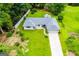 Aerial view of ranch-style home with well-maintained lawn, privacy fence, and long driveway at 65 Pine Haven Ct, Carrollton, GA 30116