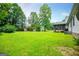 Large green backyard with a screened in porch at 65 Pine Haven Ct, Carrollton, GA 30116