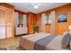 Staged bedroom with warm-toned walls, neutral bedding, and hardwood floors at 65 Pine Haven Ct, Carrollton, GA 30116