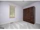 Bright bedroom with a large, dark-stained wardrobe and natural light from the window at 65 Pine Haven Ct, Carrollton, GA 30116