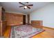 Spacious bedroom featuring hardwood floors, ceiling fan, and built-in shelving at 65 Pine Haven Ct, Carrollton, GA 30116