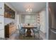 Staged dining area with rustic table, blue chairs, buffet, built-in storage, and a chandelier at 65 Pine Haven Ct, Carrollton, GA 30116