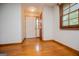 Bright entryway featuring a white front door, natural light, and hardwood floors at 65 Pine Haven Ct, Carrollton, GA 30116