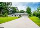 Charming one-story home featuring a well-maintained lawn, mature trees, and attached two-car garage at 65 Pine Haven Ct, Carrollton, GA 30116
