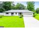 Charming home featuring a well-maintained lawn and a convenient two-car garage at 65 Pine Haven Ct, Carrollton, GA 30116