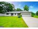 Charming ranch-style home with a well-manicured lawn, a two-car garage, and gray trim at 65 Pine Haven Ct, Carrollton, GA 30116