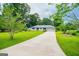 Inviting one-story home with an attached two-car garage, surrounded by mature trees and green lawn at 65 Pine Haven Ct, Carrollton, GA 30116