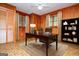 Home office featuring built-in bookshelves, wooden desk and hardwood floors at 65 Pine Haven Ct, Carrollton, GA 30116