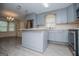 Kitchen featuring an island, stainless steel appliances, wood-look flooring, and pale blue cabinetry at 65 Pine Haven Ct, Carrollton, GA 30116