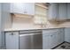 Updated kitchen featuring blue cabinets, stainless steel appliances, and modern countertops by the sink at 65 Pine Haven Ct, Carrollton, GA 30116