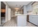 Open kitchen with island and view into the breakfast area, featuring stainless appliances and blue cabinetry at 65 Pine Haven Ct, Carrollton, GA 30116
