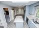 Bright kitchen with stainless steel appliances and a cozy eat-in island, offering a great space for entertaining at 65 Pine Haven Ct, Carrollton, GA 30116