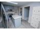 Well-lit kitchen featuring stainless steel appliances, an island, and wood-look flooring, with modern cabinetry at 65 Pine Haven Ct, Carrollton, GA 30116