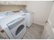 Clean laundry room with modern washer and dryer units, cabinets for storage, and modern floors at 65 Pine Haven Ct, Carrollton, GA 30116