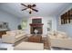Staged living room showcases a brick fireplace and cozy furnishings at 65 Pine Haven Ct, Carrollton, GA 30116
