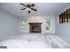 Empty living room featuring neutral carpet, fireplace, and natural light at 65 Pine Haven Ct, Carrollton, GA 30116