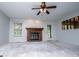 Bright living room featuring a fireplace, ceiling fan, and ample natural light at 65 Pine Haven Ct, Carrollton, GA 30116