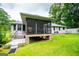 View of the screened in porch and lush green backyard at 65 Pine Haven Ct, Carrollton, GA 30116