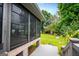Screened porch with brick columns and gray deck overlooks landscaped yard at 65 Pine Haven Ct, Carrollton, GA 30116