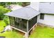 Elevated view of a screened porch addition with gray roof, brick foundation, and deck at 65 Pine Haven Ct, Carrollton, GA 30116