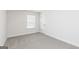 Clean bedroom with neutral carpet, white walls and trim, and a window with blinds at 500 Cantrell Drive, Dallas, GA 30157