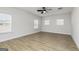 A serene bedroom with neutral walls, wood-look floors, and multiple windows offering plenty of natural light at 500 Cantrell Drive, Dallas, GA 30157