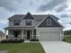 Inviting two-story home featuring a neutral palette, attached two-car garage, and tastefully landscaped front yard at 500 Cantrell Drive, Dallas, GA 30157