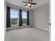 Bedroom featuring carpeted floor, blue curtains, and a ceiling fan for a modern and comfortable space at 2118 Iverson Se Dr, Smyrna, GA 30080