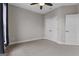 A cozy bedroom with plush carpet, a ceiling fan, and white closet doors for ample storage space at 2118 Iverson Se Dr, Smyrna, GA 30080