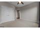 Bedroom showcasing plush carpet, double doors, a ceiling fan, and neutral paint, creating a serene retreat at 2118 Iverson Se Dr, Smyrna, GA 30080