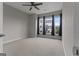 Bright bedroom with plush carpeting, blue curtains, large windows, and a ceiling fan at 2118 Iverson Se Dr, Smyrna, GA 30080