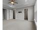 Spacious bedroom with neutral tones, a ceiling fan, and multiple doorway access at 2118 Iverson Se Dr, Smyrna, GA 30080