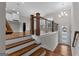 Elegant foyer with hardwood floors, staircase, and stylish chandelier at 2118 Iverson Se Dr, Smyrna, GA 30080
