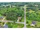 An aerial view of a beautiful neighborhood featuring a home surrounded by lush trees and well-maintained lawns at 52 Olivia Ct, Palmetto, GA 30268