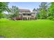 Spacious backyard showcasing a deck, patio, and well-maintained lawn at 52 Olivia Ct, Palmetto, GA 30268