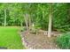 Secluded backyard with a small shed and tranquil wooded backdrop at 52 Olivia Ct, Palmetto, GA 30268