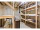 Basement showing open wooden shelving and concrete foundation at 52 Olivia Ct, Palmetto, GA 30268