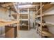 Unfinished basement with exposed ceiling, wooden shelving and concrete floor at 52 Olivia Ct, Palmetto, GA 30268
