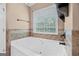 Bathroom showcases a soaking tub and a window view, creating a relaxing and spa-like atmosphere in the home at 52 Olivia Ct, Palmetto, GA 30268
