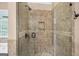 Tiled walk-in shower features a glass door and a built-in niche offering a luxurious, spa-like bathing experience at 52 Olivia Ct, Palmetto, GA 30268