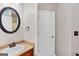 Half bathroom featuring a round mirror and vanity at 52 Olivia Ct, Palmetto, GA 30268