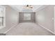 Large bedroom featuring a tray ceiling, ceiling fan, and windows for plenty of light at 52 Olivia Ct, Palmetto, GA 30268
