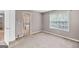 Spacious bedroom features neutral tones, plush carpeting, and a window with natural light, offering a serene retreat at 52 Olivia Ct, Palmetto, GA 30268