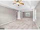Spacious bedroom with tray ceiling, fan, natural light, and access to the ensuite bathroom at 52 Olivia Ct, Palmetto, GA 30268