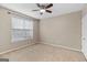 Bright bedroom with neutral carpet, a ceiling fan, and a window providing natural light at 52 Olivia Ct, Palmetto, GA 30268